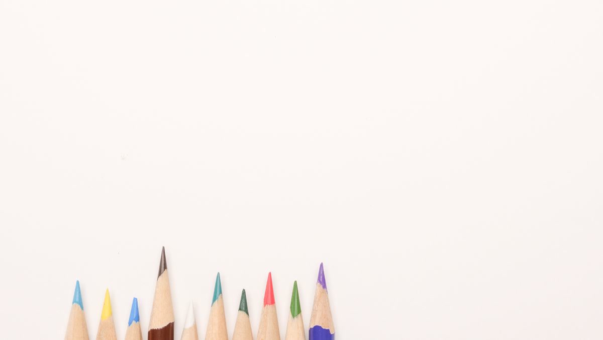 A completed coloring page done entirely in monochromatic blue tones, showing depth from navy to pale sky blue, Prismacolor pencils in blue shades arranged beside it