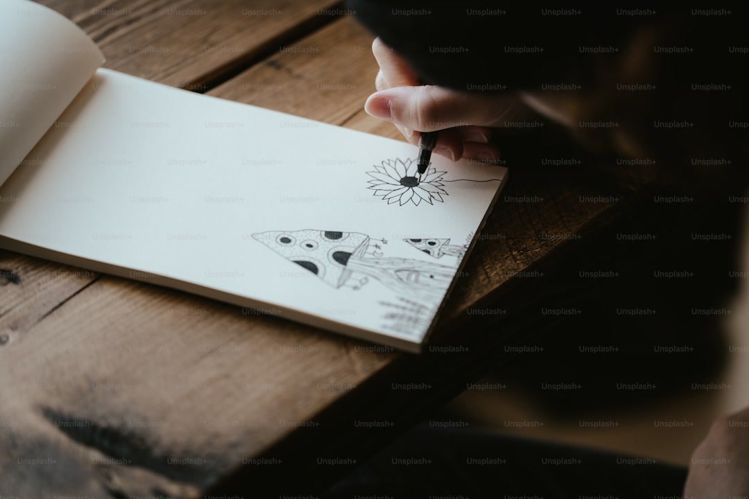 Hands coloring detailed pattern in adult coloring book with colored pencils