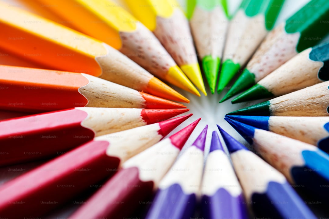 Close-up of hands blending Prismacolor colored pencils on a coloring book page with circular strokes