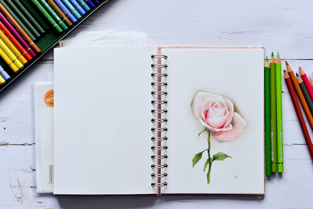 Faber-Castell Albrecht Durer watercolor pencils arranged in a color swatch gradient with a water brush creating smooth washes on watercolor paper