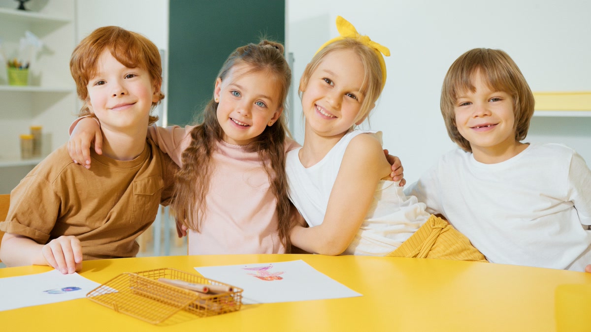 Group of people laughing and coloring together at a table with colorful supplies
