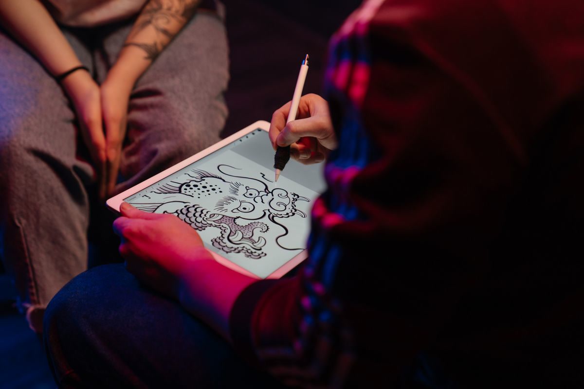 Person using a tablet for creative work