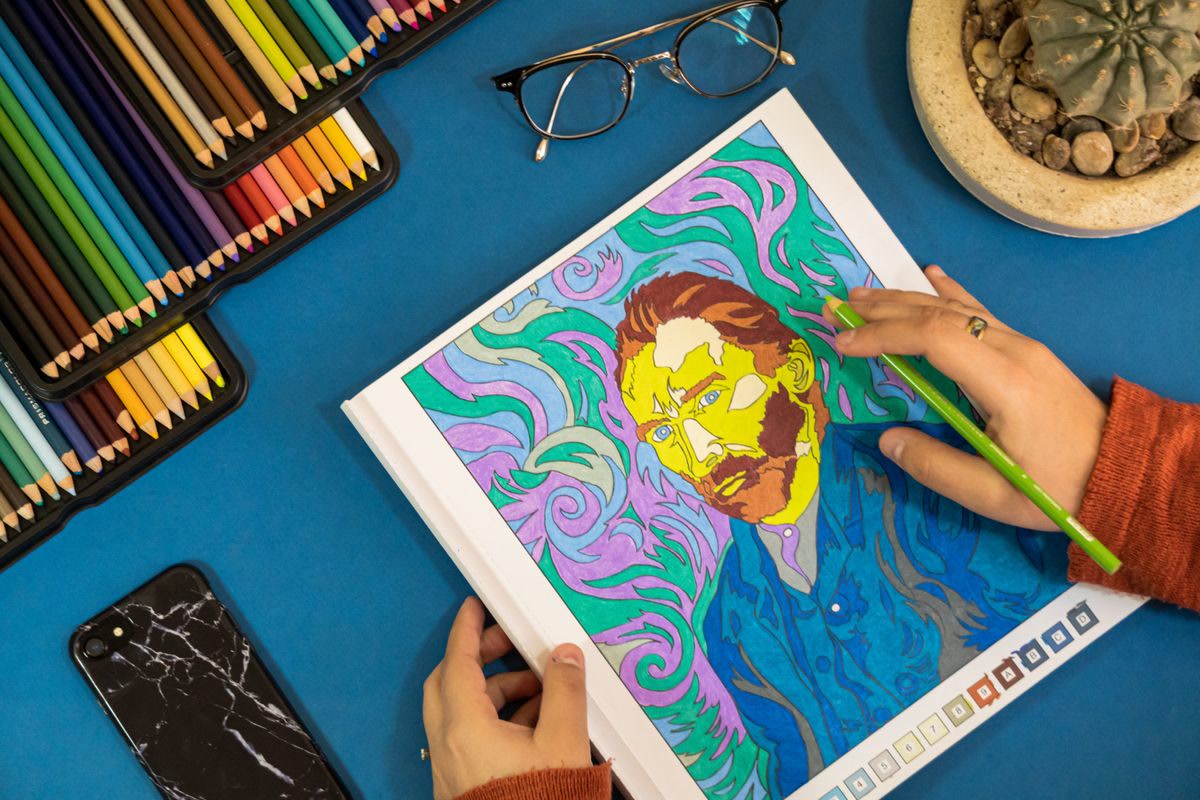 Open coloring book with art supplies