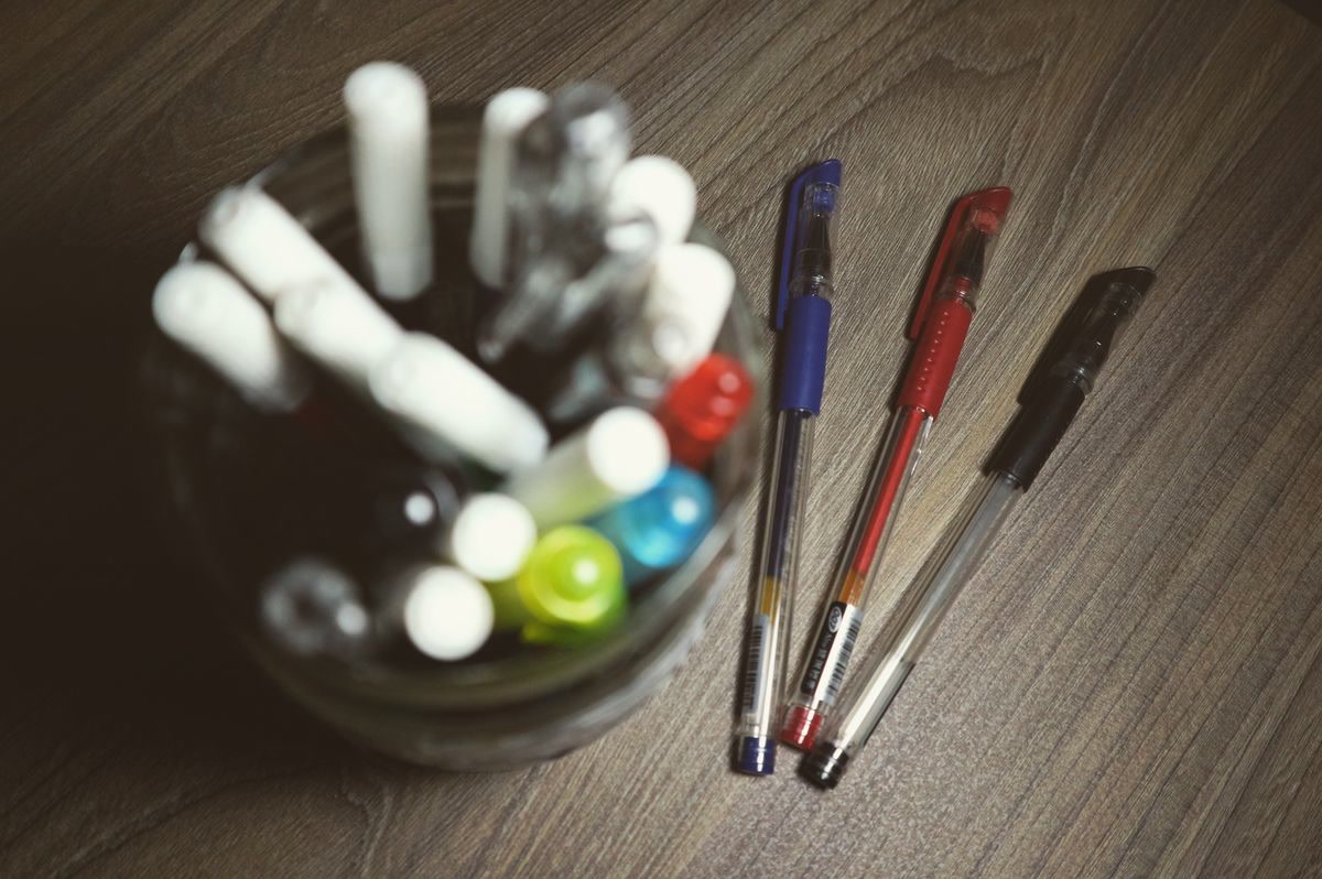 Gel pens and art supplies on a desk