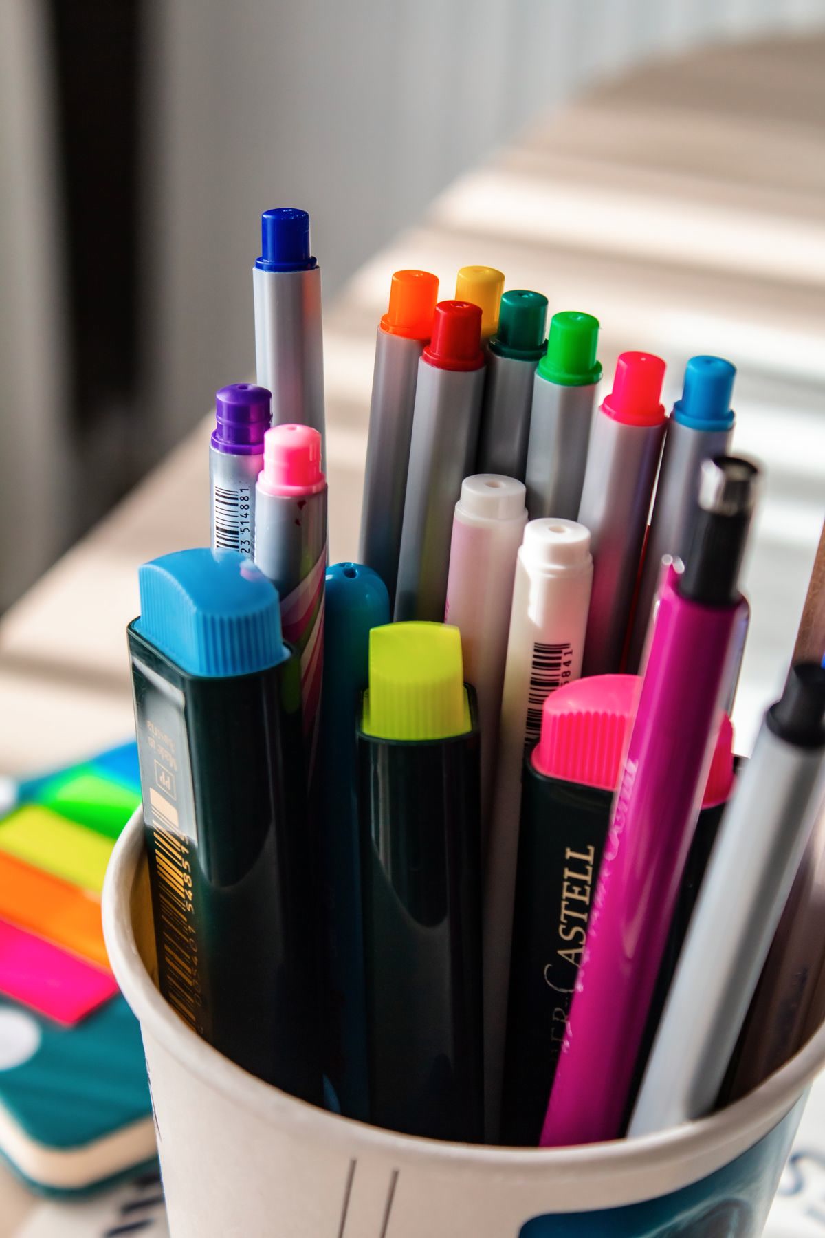 Colorful markers and pens arranged on a desk