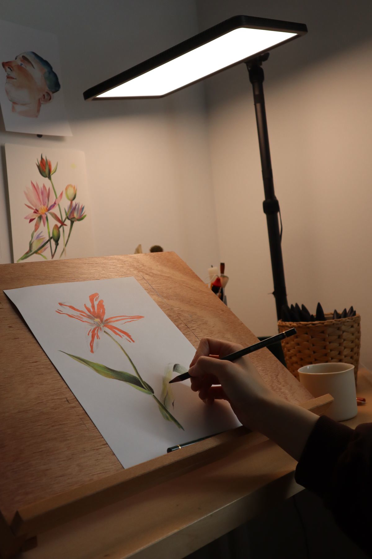 Artist working on a detailed design at a desk