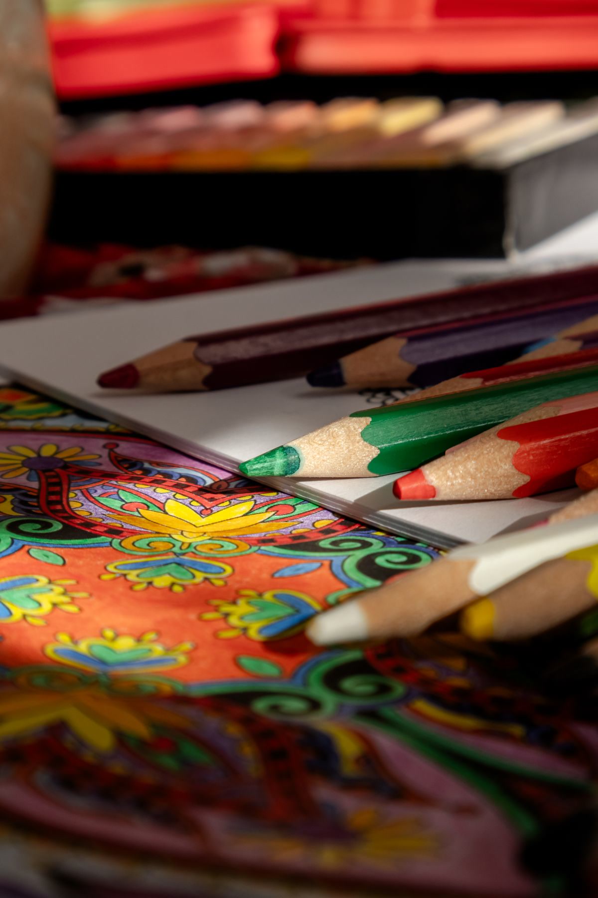Coloring book and art supplies on a desk