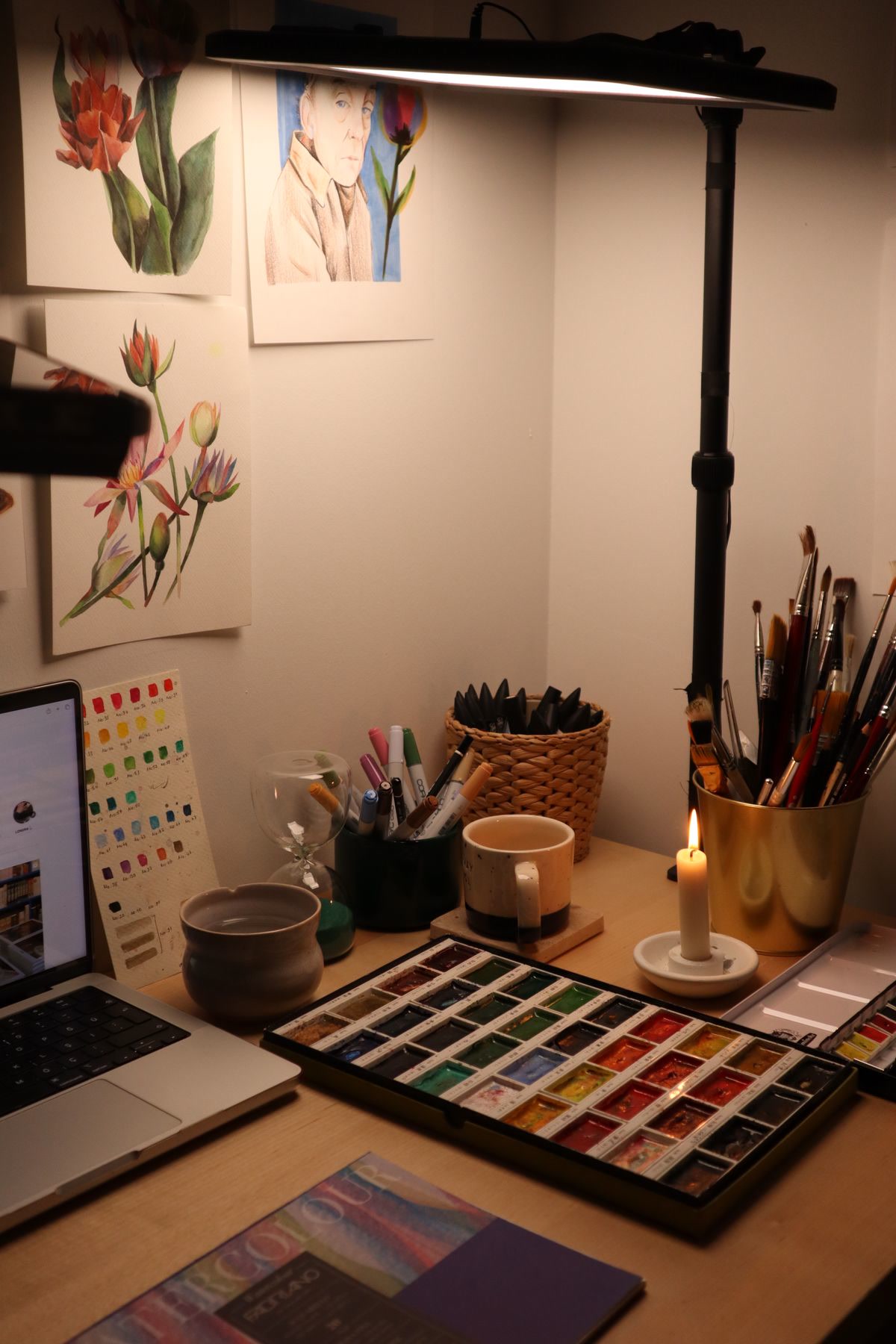 A dedicated coloring corner with an open coloring book, Prismacolor colored pencils in a cup, a soft lamp providing warm light, and a comfortable cushion on the chair, inviting and personal space, lifestyle photography