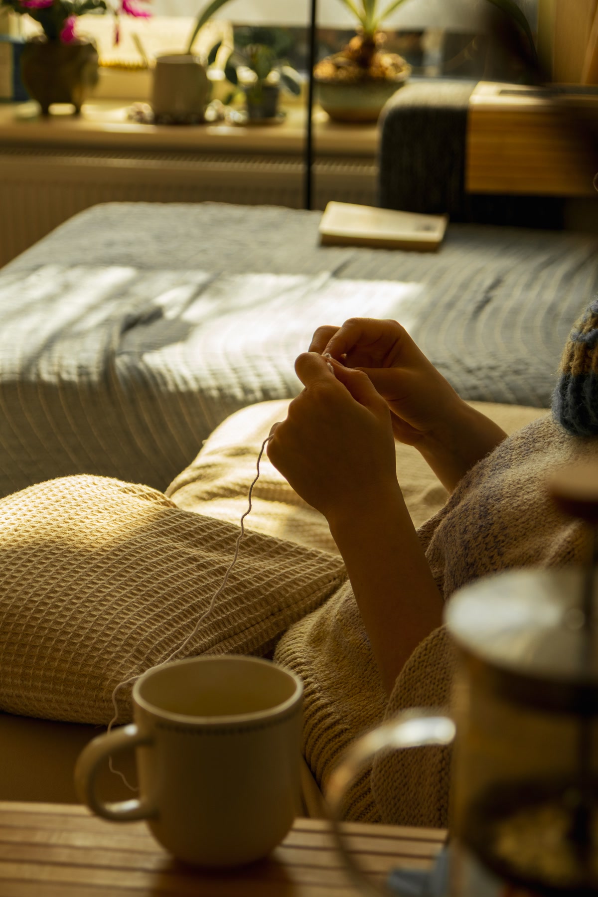 A winter coloring kit with colored pencils, a mindfulness coloring book, and a light therapy box on a bedside table, morning routine setup, warm and inviting, close-up product photography
