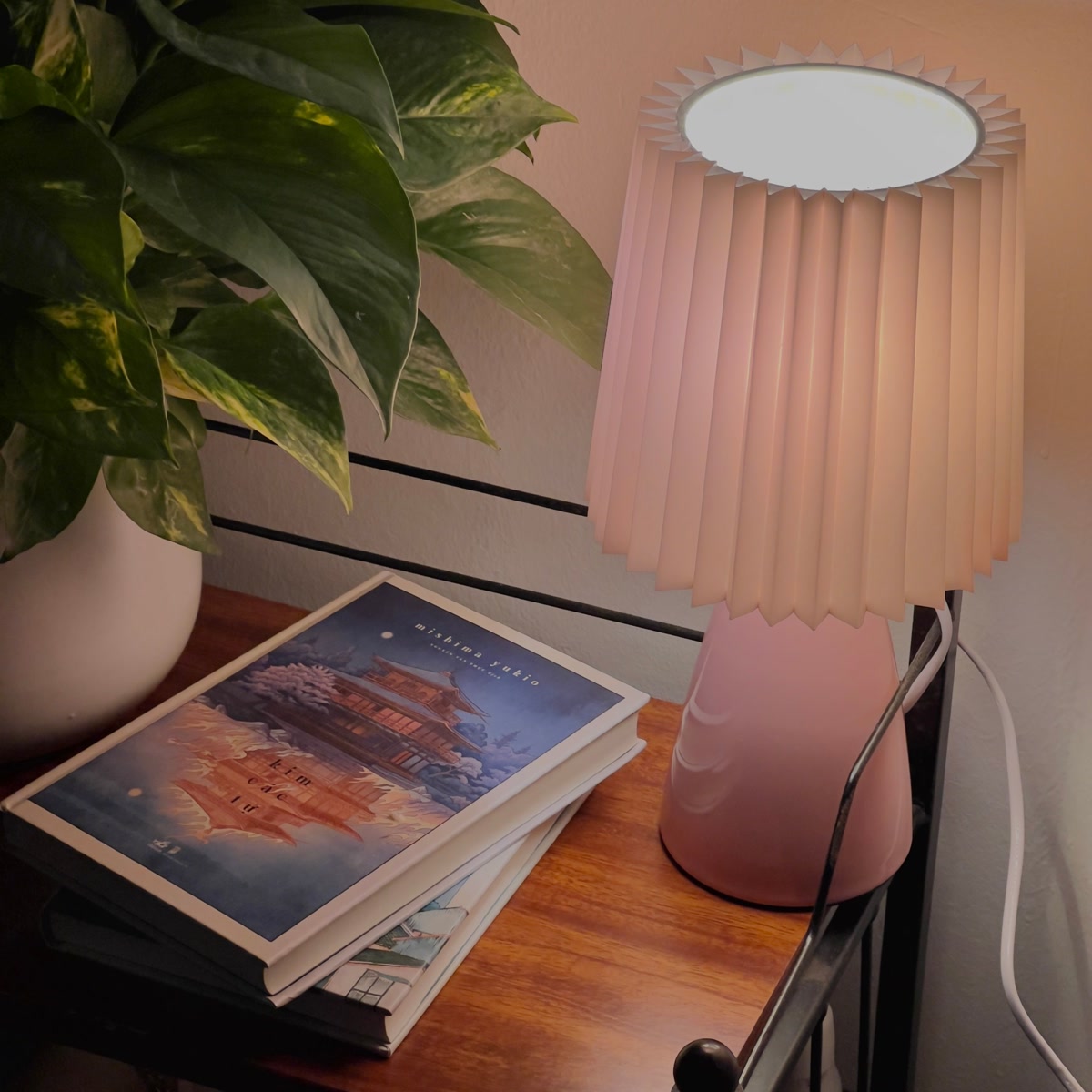 Open coloring book on bed with warm bedside light