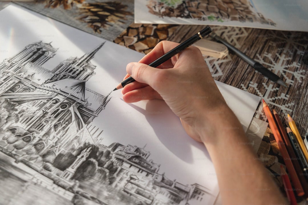 Hands coloring in a small mindfulness coloring book at a desk, colored pencils in one hand, focused and calm expression, office setting with soft natural light, close-up lifestyle photography