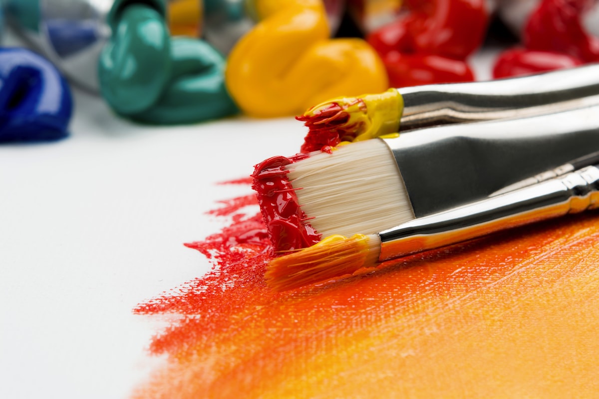 Close-up of colored pencil work showing gold and silver metallic effects on paper